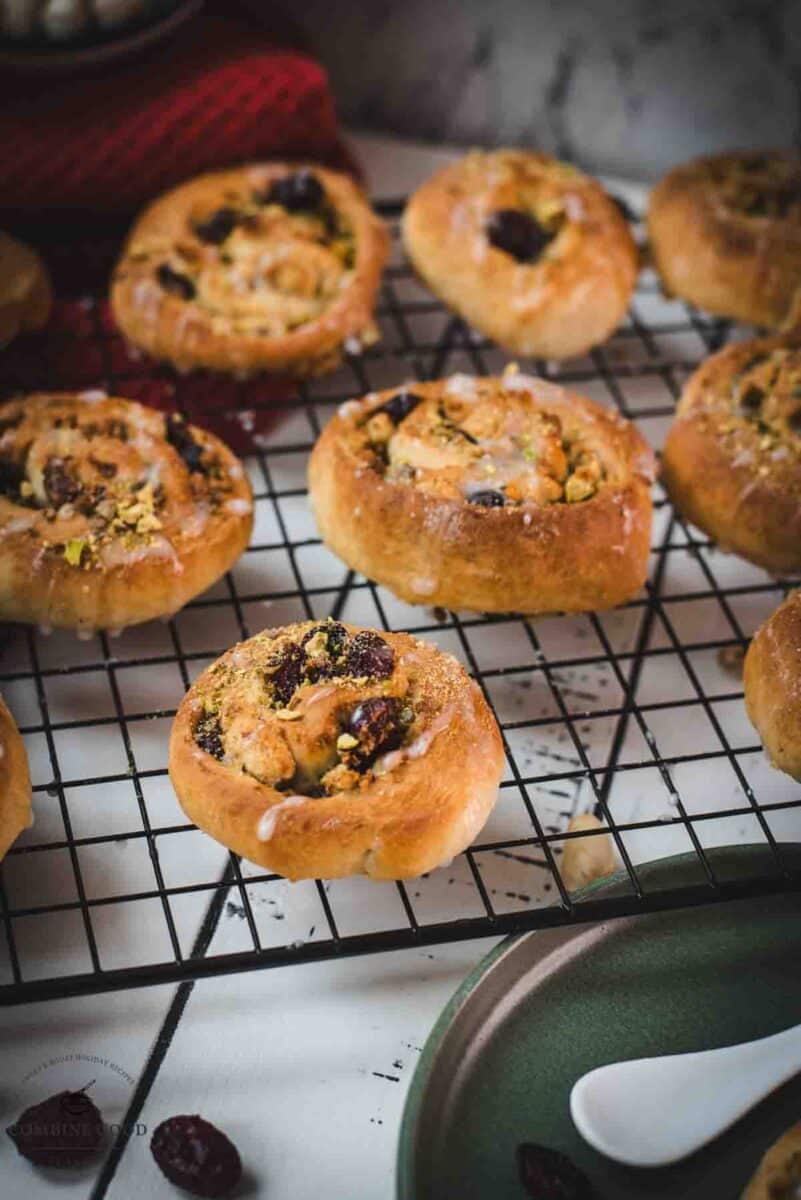 Delicious, mini pistachio sweet rolls on cooling rack.