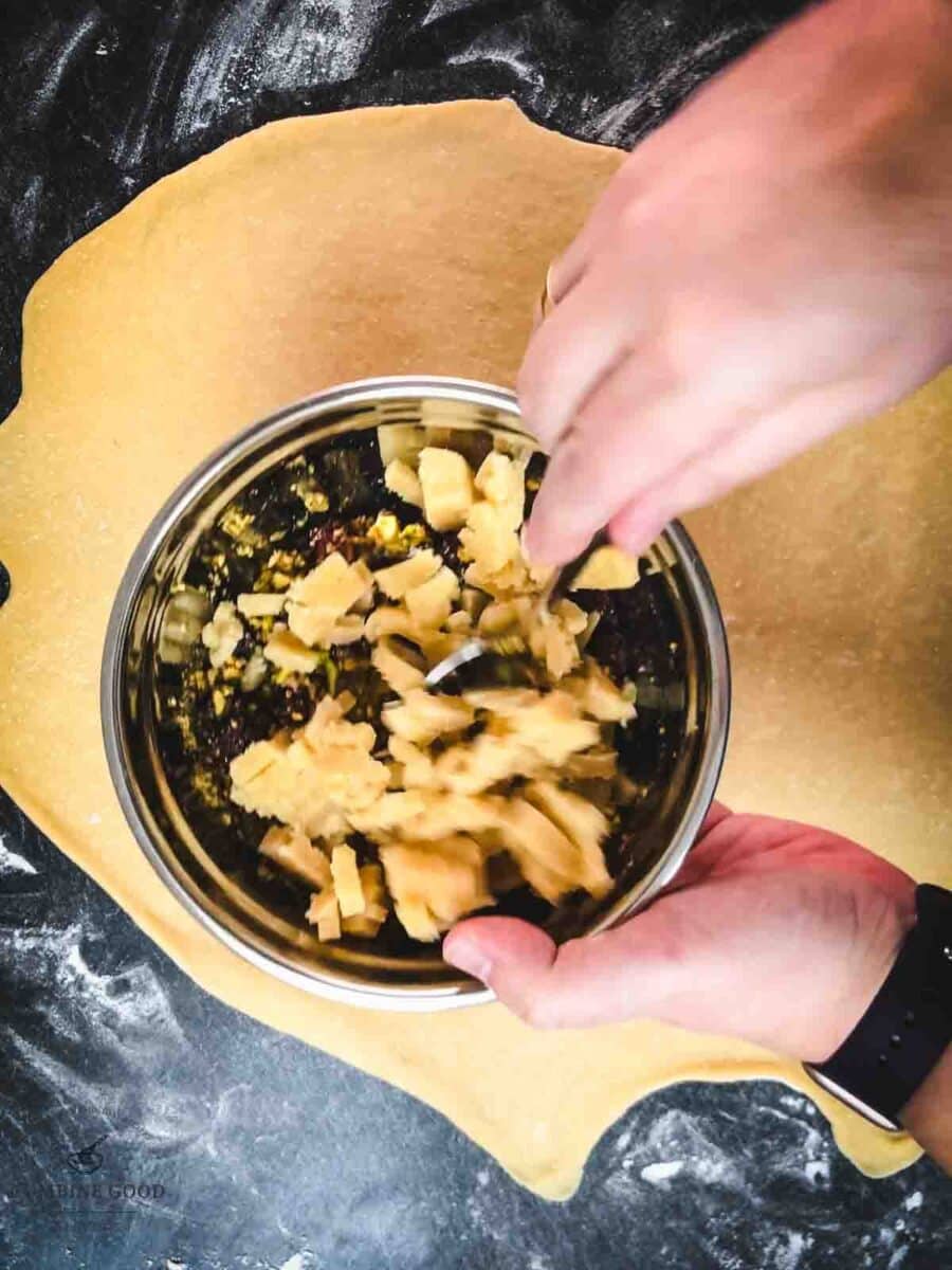 Combine the egg white, chopped pistachios, cranberries, and marzipan in a mixing bowl.