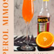 Gorgeous sparkling wine glass, with engraved heart and two crystals, filled with delicious Aperol Mimosa. Placed on heartshaped black slate coaster.