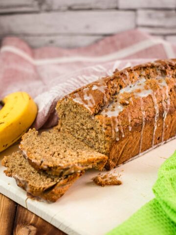 Delicious low sugar banana loaf bread, with light sugar glaze drizzled over the banana bread.