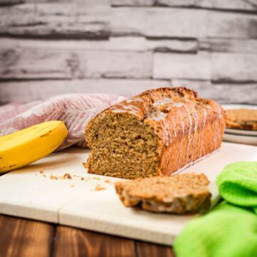 Delicious low sugar banana loaf bread, with light sugar glaze drizzled over the banana bread.