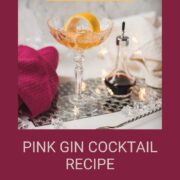 Cocktail glass filled with an elegant pink gin cocktail.