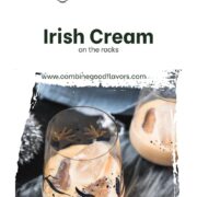 Cute tumbler glasses filled with delicious Baileys Irish Cream on the rocks. Placed on marbled plate.