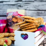 Soft, chewy and sweet strawberry cookies with white chocolate chips placed in a gorgeous white wooden crate.