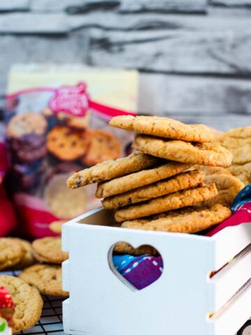 Soft, chewy and sweet strawberry cookies with white chocolate chips placed in a gorgeous white wooden crate.