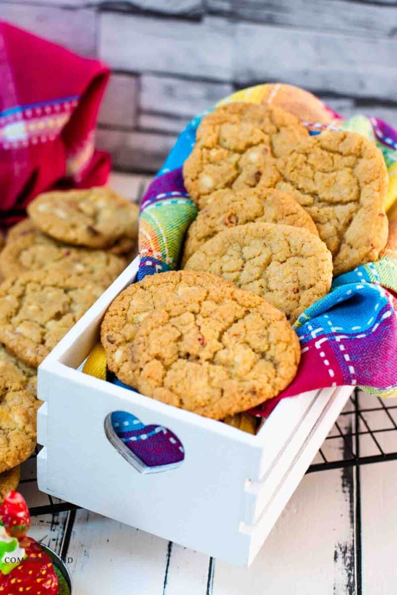 Soft, chewy and sweet strawberry cookies with white chocolate chips placed in a gorgeous white wooden crate.