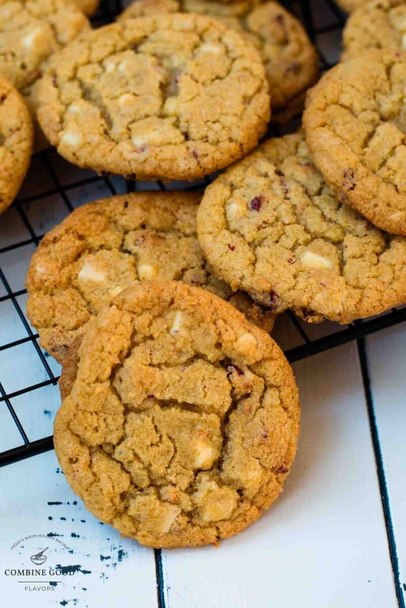 Soft, chewy and sweet strawberry cookies with white chocolate chips scattered on a cooling rack.