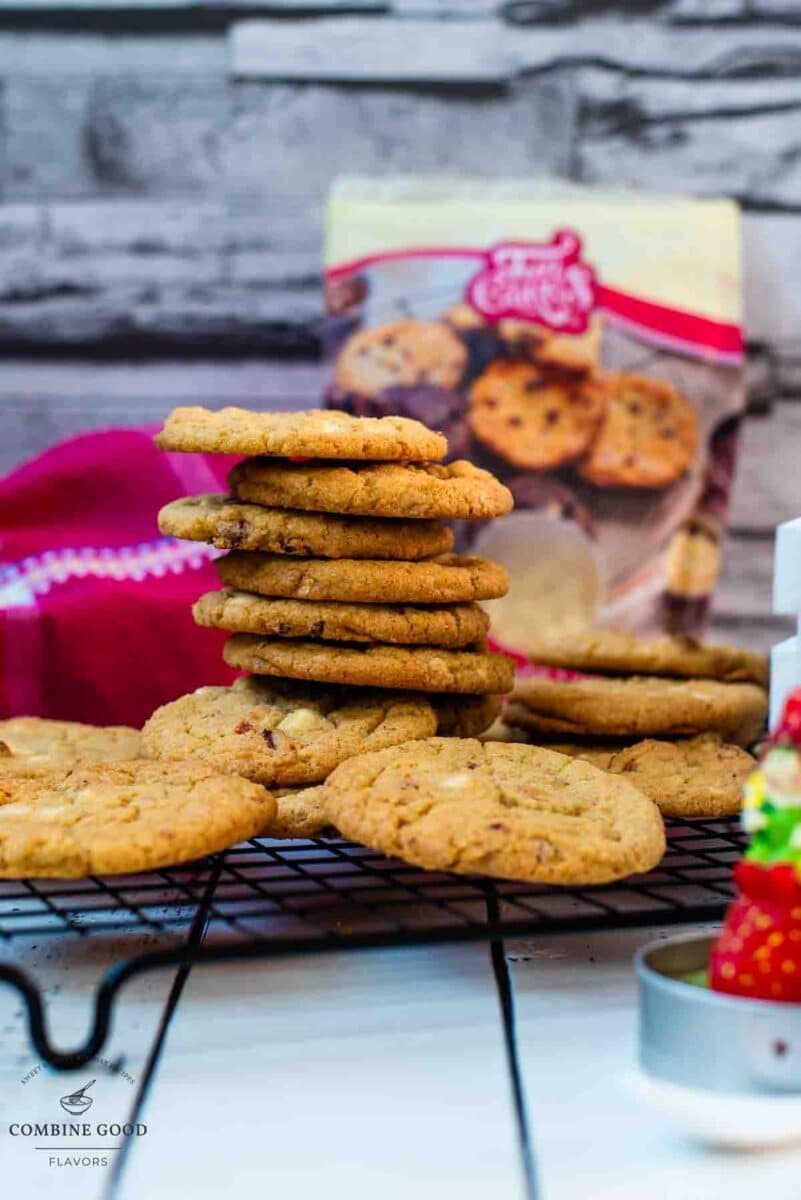 Soft, chewy, and sweet strawberry white chocolate chip cookies, stacked on a cooling rack.