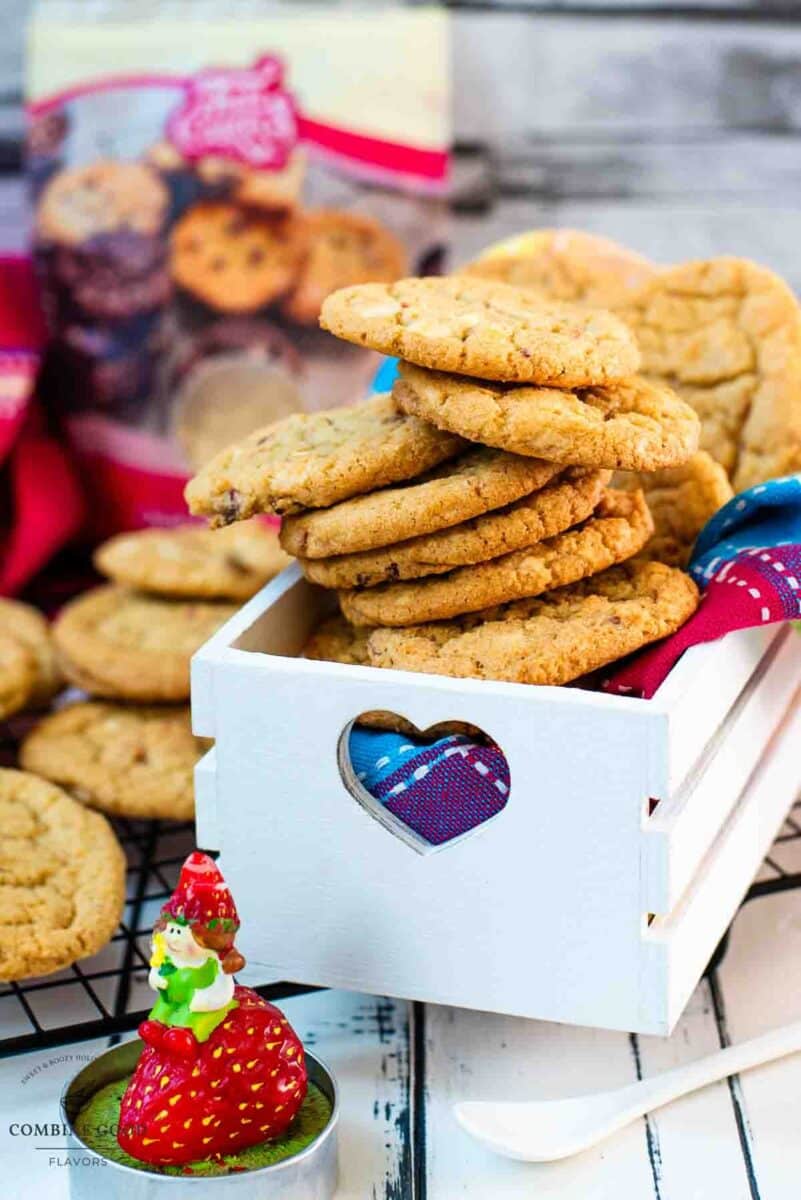 Soft, chewy and sweet strawberry cookies with white chocolate chips placed in a gorgeous white wooden crate.