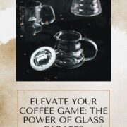Gorgeous glass carafes, placed on dark ground, next to scattered coffee beans.