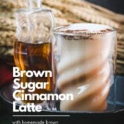 Curved glass filled with delicious brown sugar cinnamon latte, placed in a cast iron pan on a green felt base.