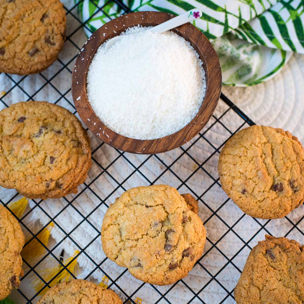 Delicious coconut chocolate chip cookies, on a cooling rack.
