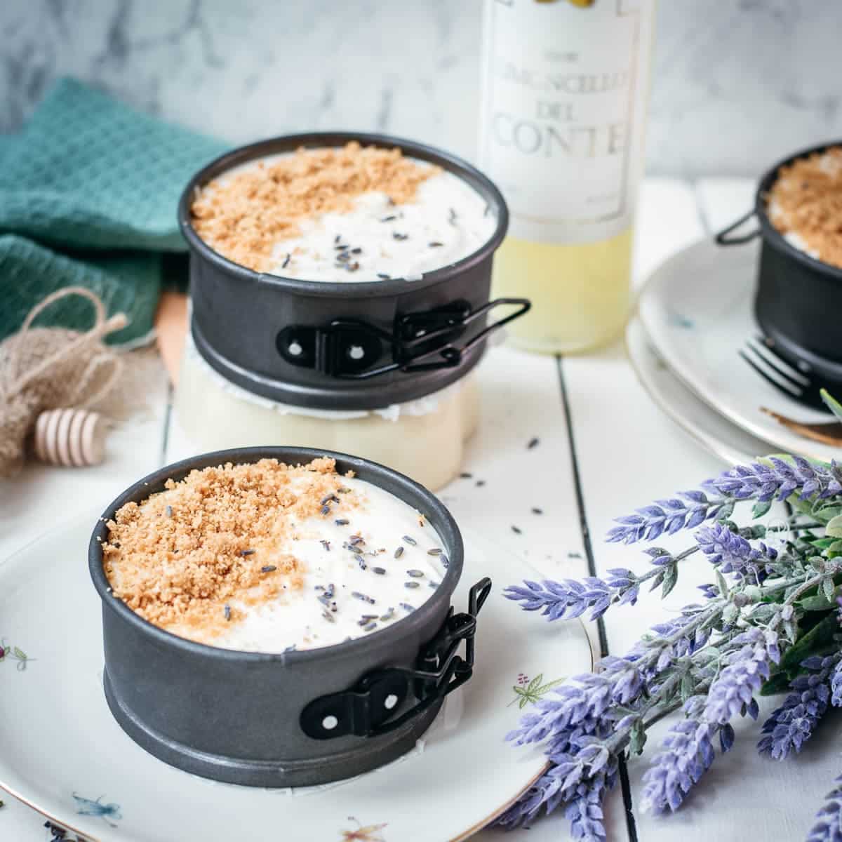 Adorable mini no bake cheesecakes with lavender and limoncello, placed on plates with a floral pattern.