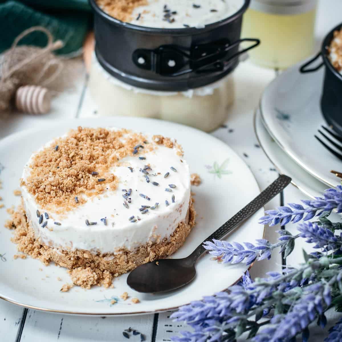 Adorable mini no bake cheesecakes with lavender and limoncello, placed on plates with a floral pattern.