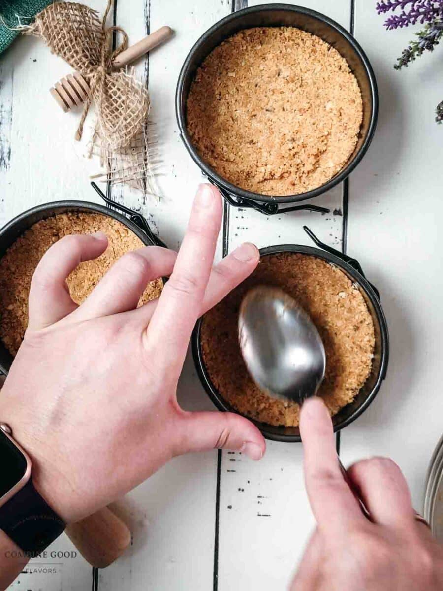 Press the lavender graham cracker crumbs into the prepared mini springform pans.