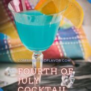 Gorgeous blue lady cocktail, served in vintage glass, garnished with an orange and an lemon slice side by side. Placed on a marbled plate.