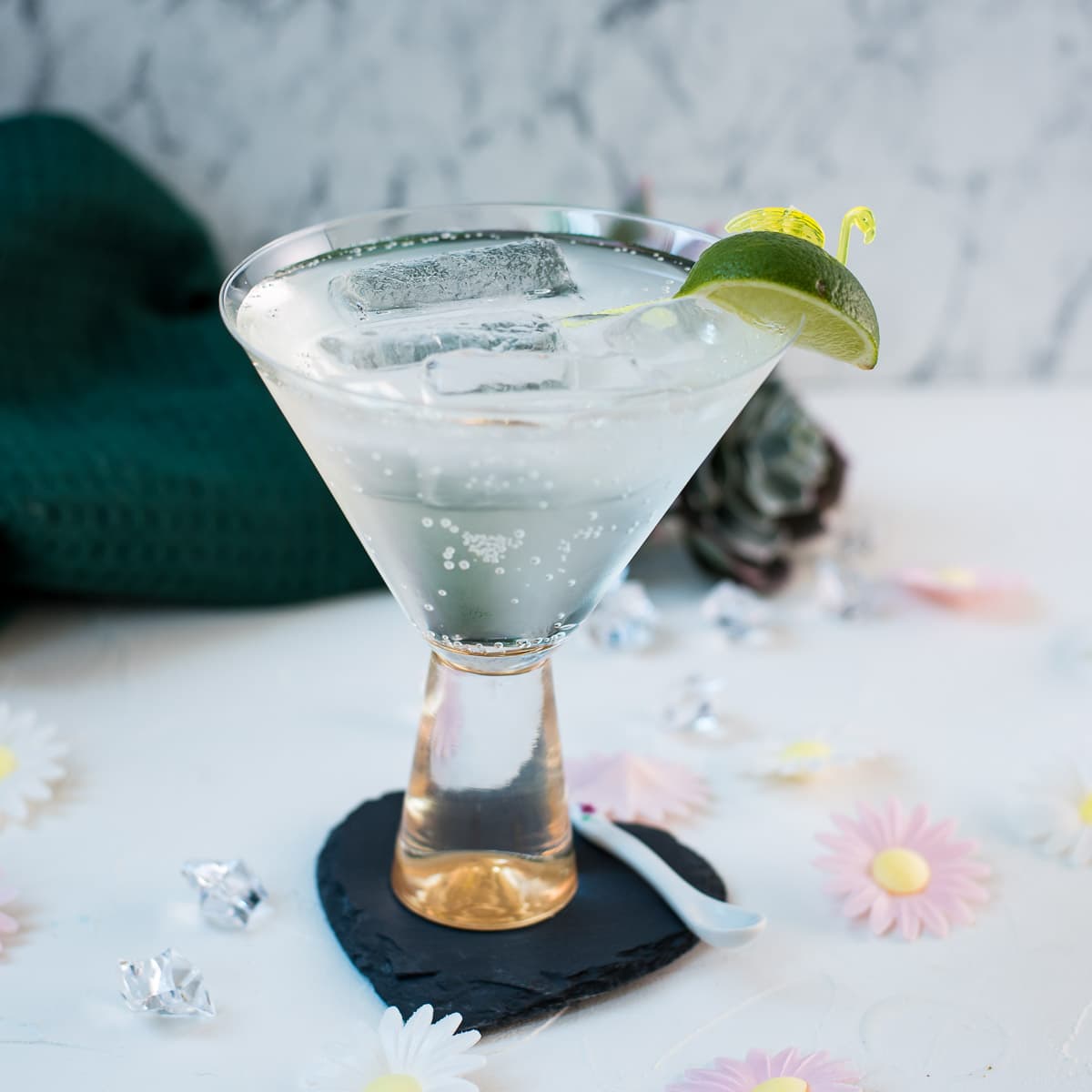 Easy and delicious! Vermouth tonic, in a gorgeous cocktail glass, placed on a black heartshaped slate coaster.