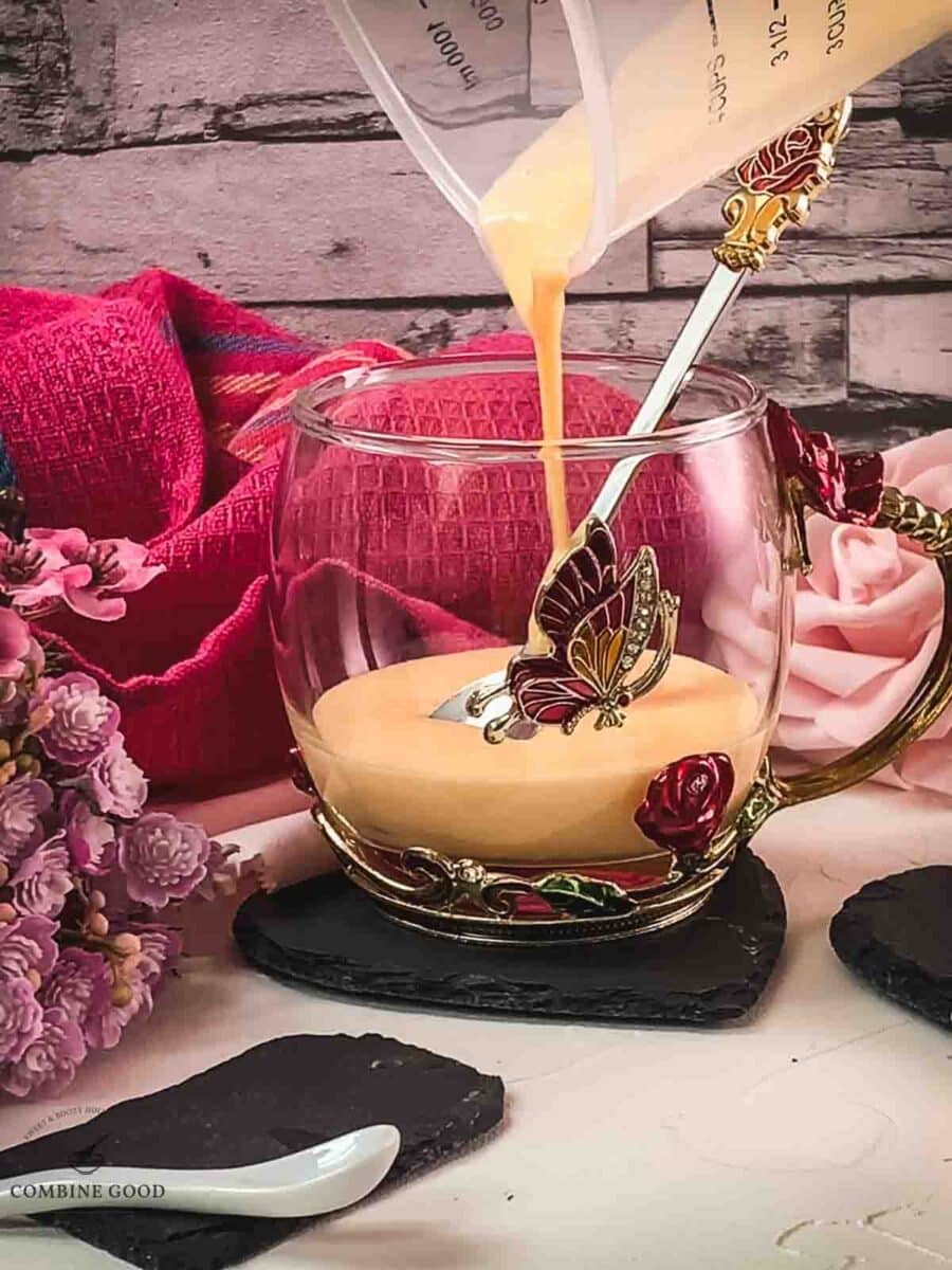 Pour the whipped up egg yolk sugar Maraschino mixture into the serving glass.