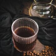 Serving glass filled with delicious black coffee.
