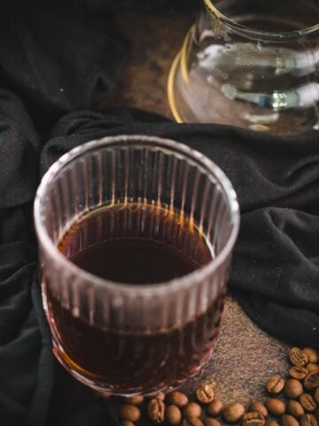 Serving glass filled with delicious black coffee.