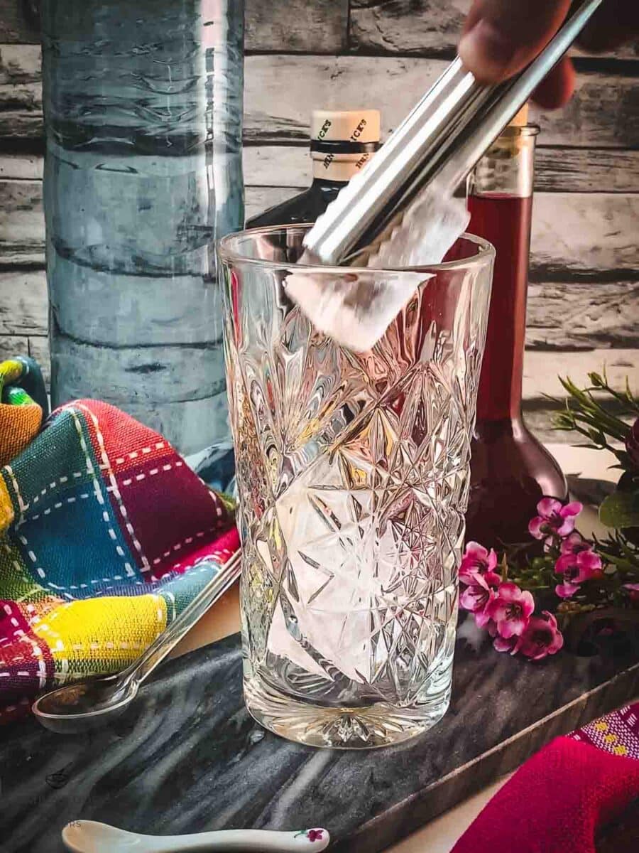 Add cubed ice to your serving glass.