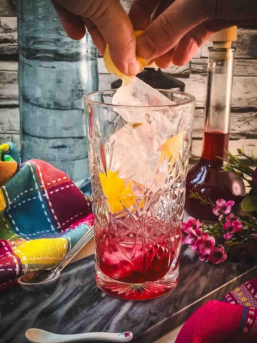 Squeeze a bit lemon juice into the glass.