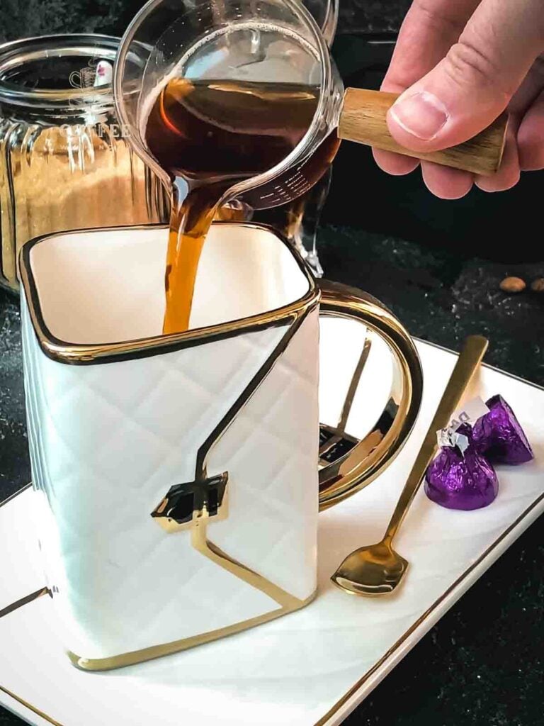 Pour freshly brewed espresso into the serving mug.