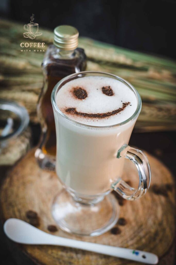 Cute brown sugar oat milk coffee, with a smiley face dusted on top of it.