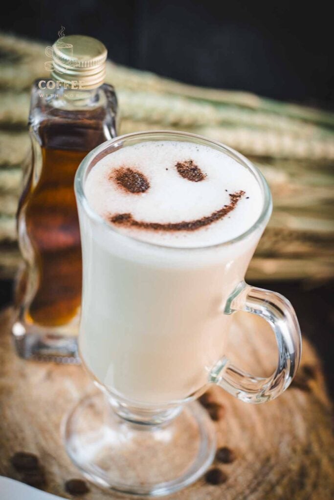Cute brown sugar oat milk coffee, with a smiley face dusted on top of it.