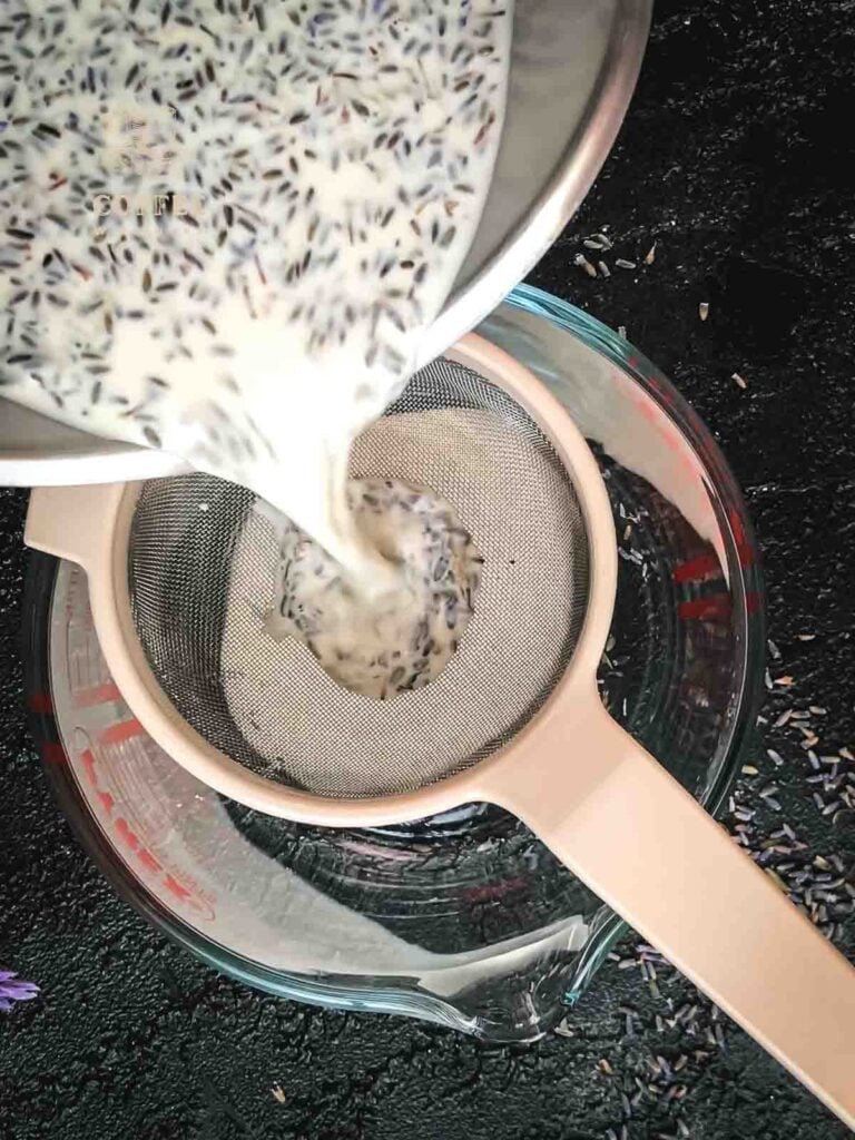 Pour the lavender heavy cream mix through a closed meshed sieve into a big Pyrex glass measuring cup.