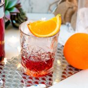 Gorgeous Negroni cocktail, served with a juice orange wedge.
