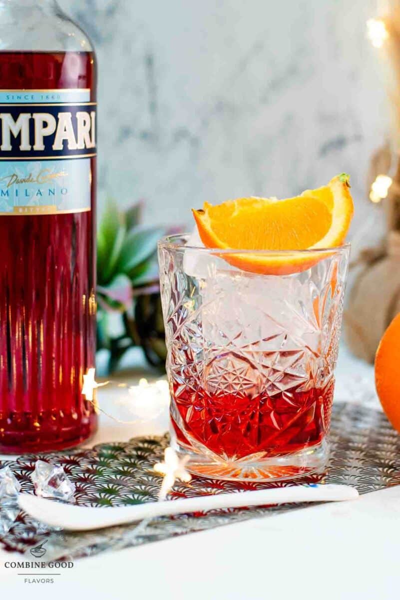 Gorgeous Negroni cocktail, served with a juice orange wedge.