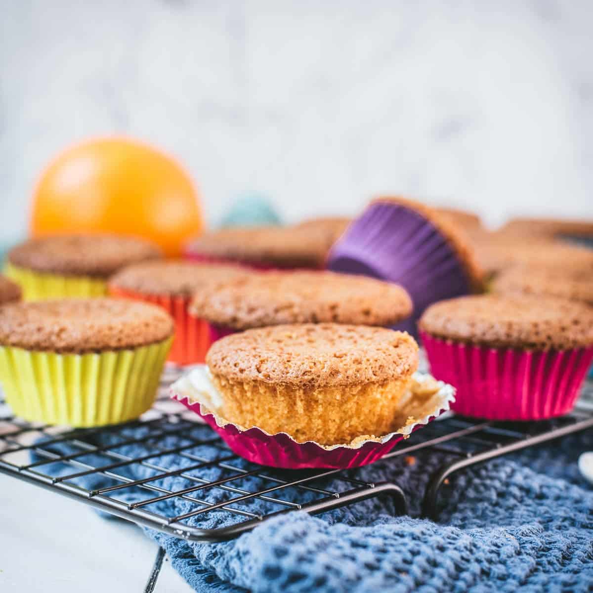 Gorgeous orange muffins placed on cooling rack.