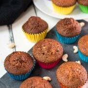 Delicious rum cashew muffins, placed on dark slate plate.