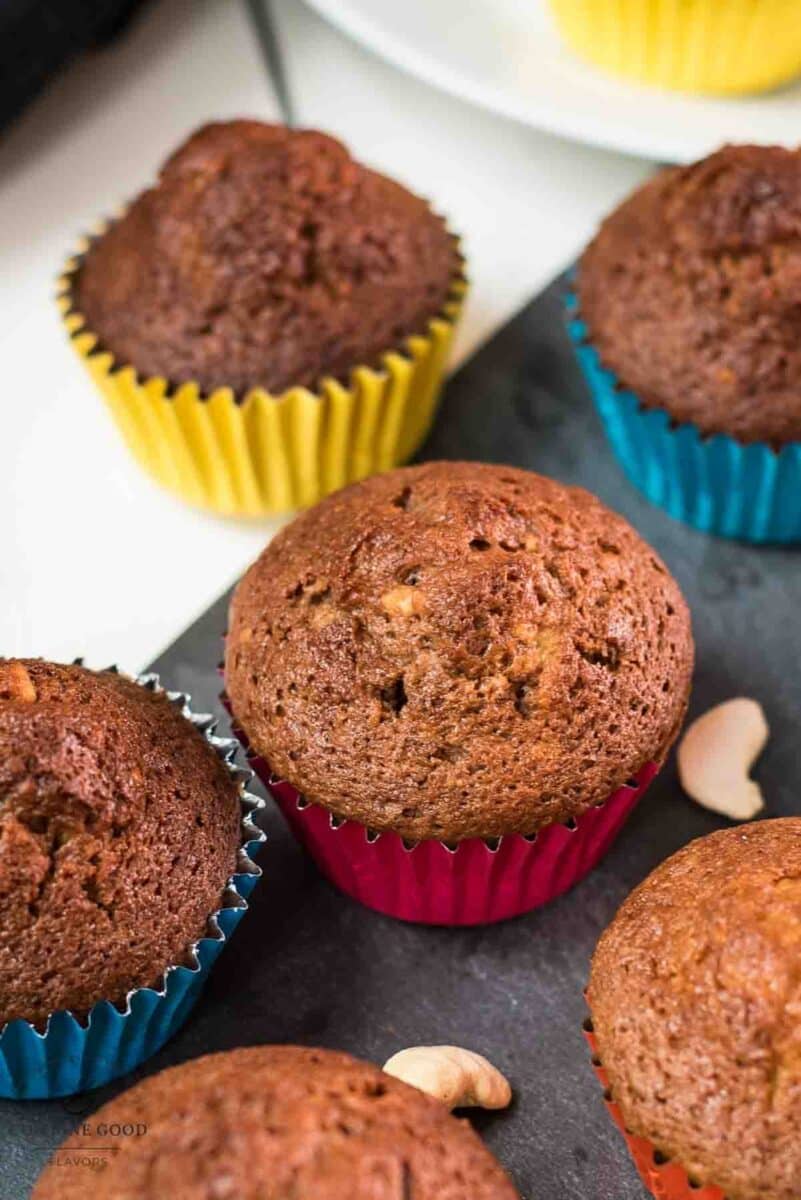Delicious rum cashew muffins, placed on dark slate plate.