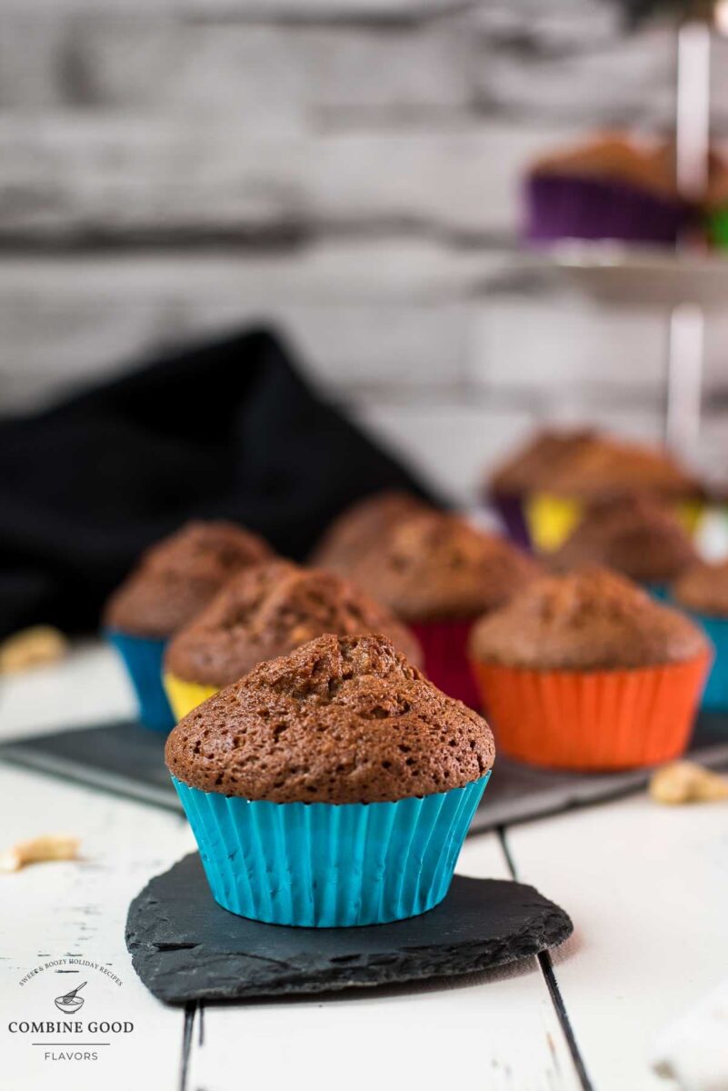 Delicious rum cashew muffins, placed on dark slate plate.