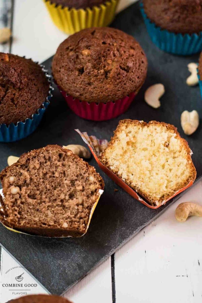 Two rum muffin halves, one with Dutch cocoa, the other without. Placed on a dark slate plate.