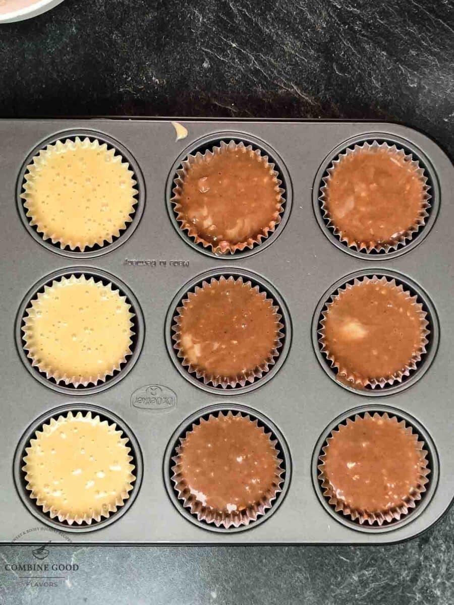Muffin tin filled with light and dark muffin batter.