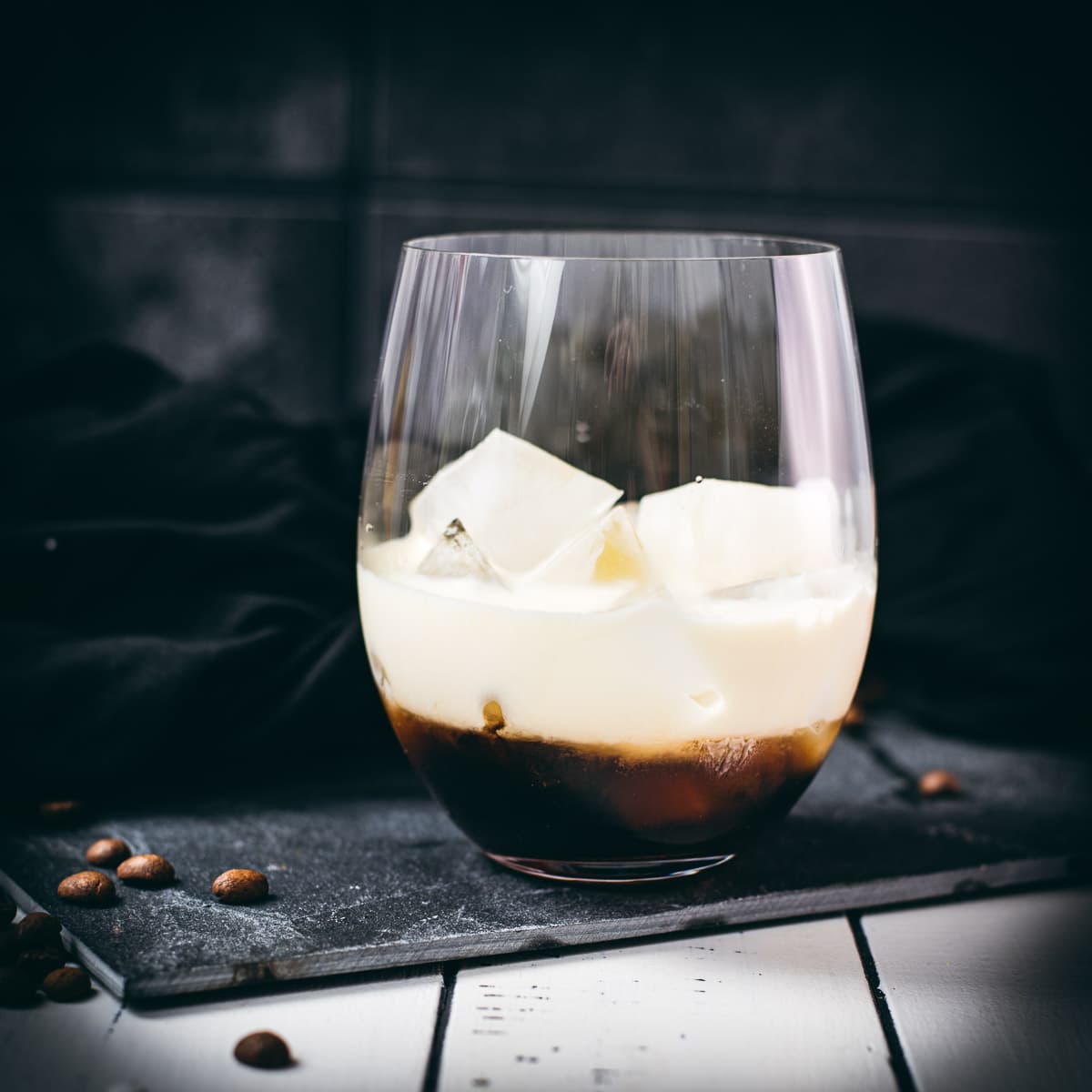 Simple GT glass, filled with delicious brown sugar white Russian. Placed on a black slate plate.