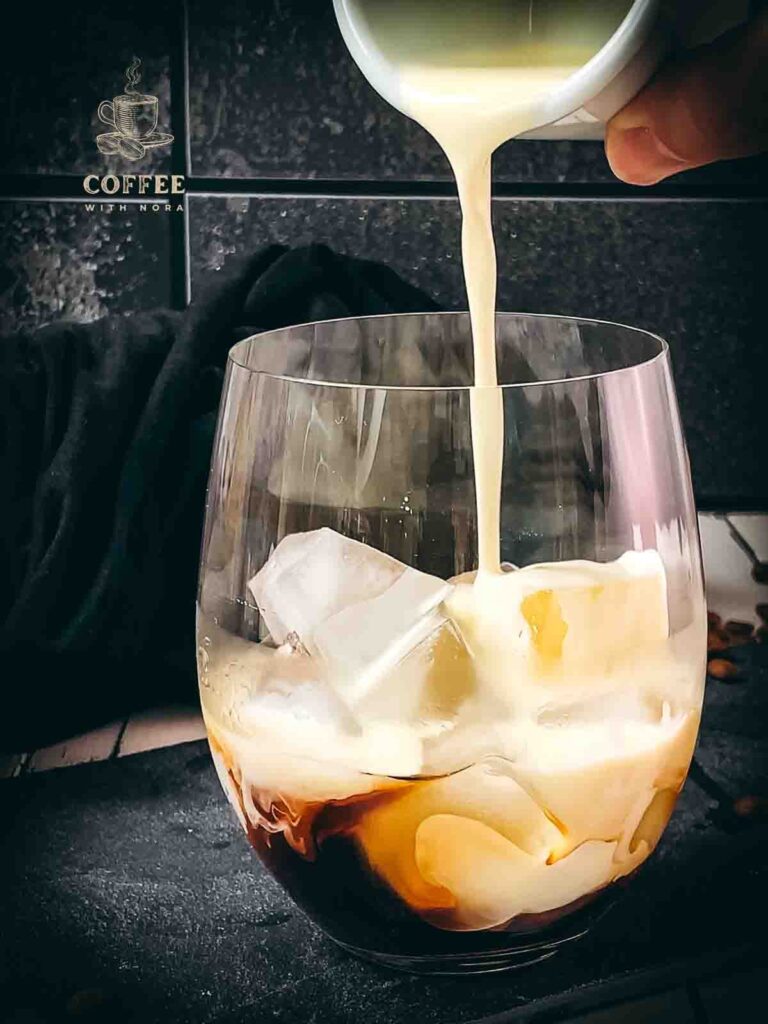 Pouring heavy cream into the glass.