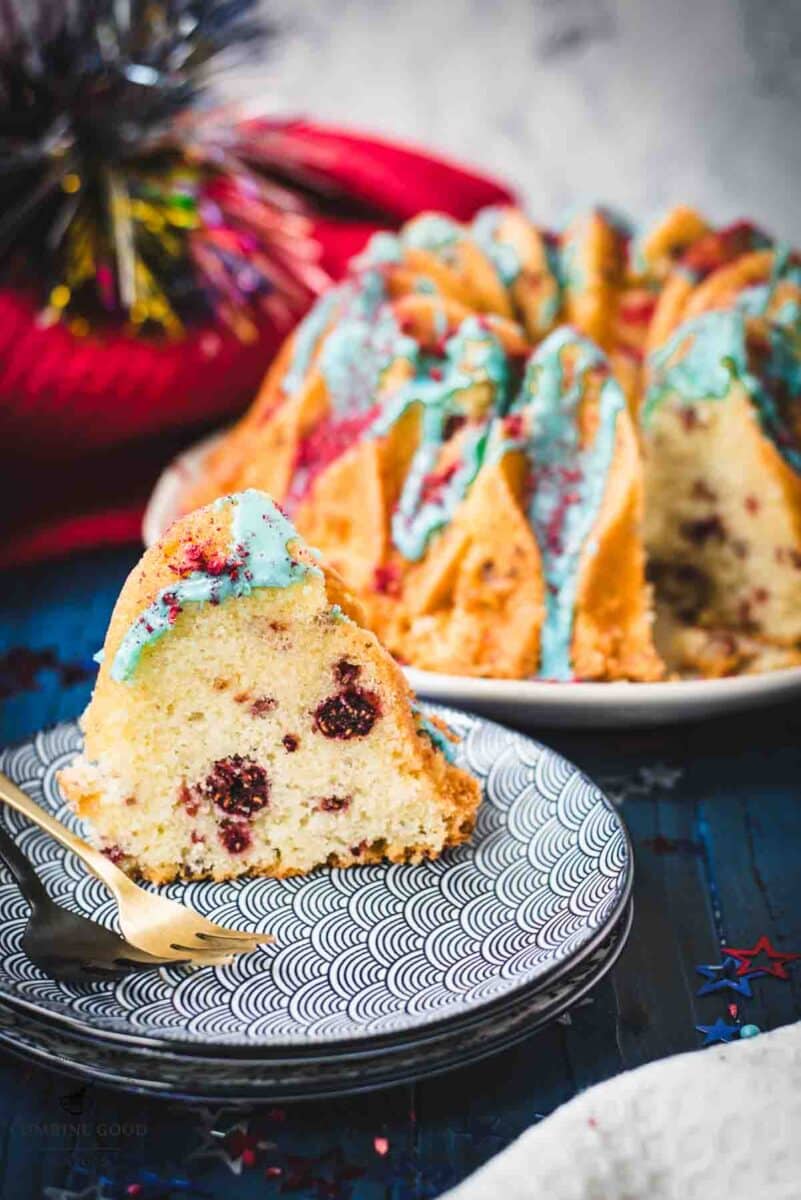 Slice of firecracker bundt cake. Placed on white blue plates.