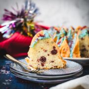 Slice of firecracker bundt cake. Placed on white blue plates.