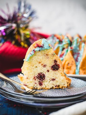 Slice of firecracker bundt cake. Placed on white blue plates.