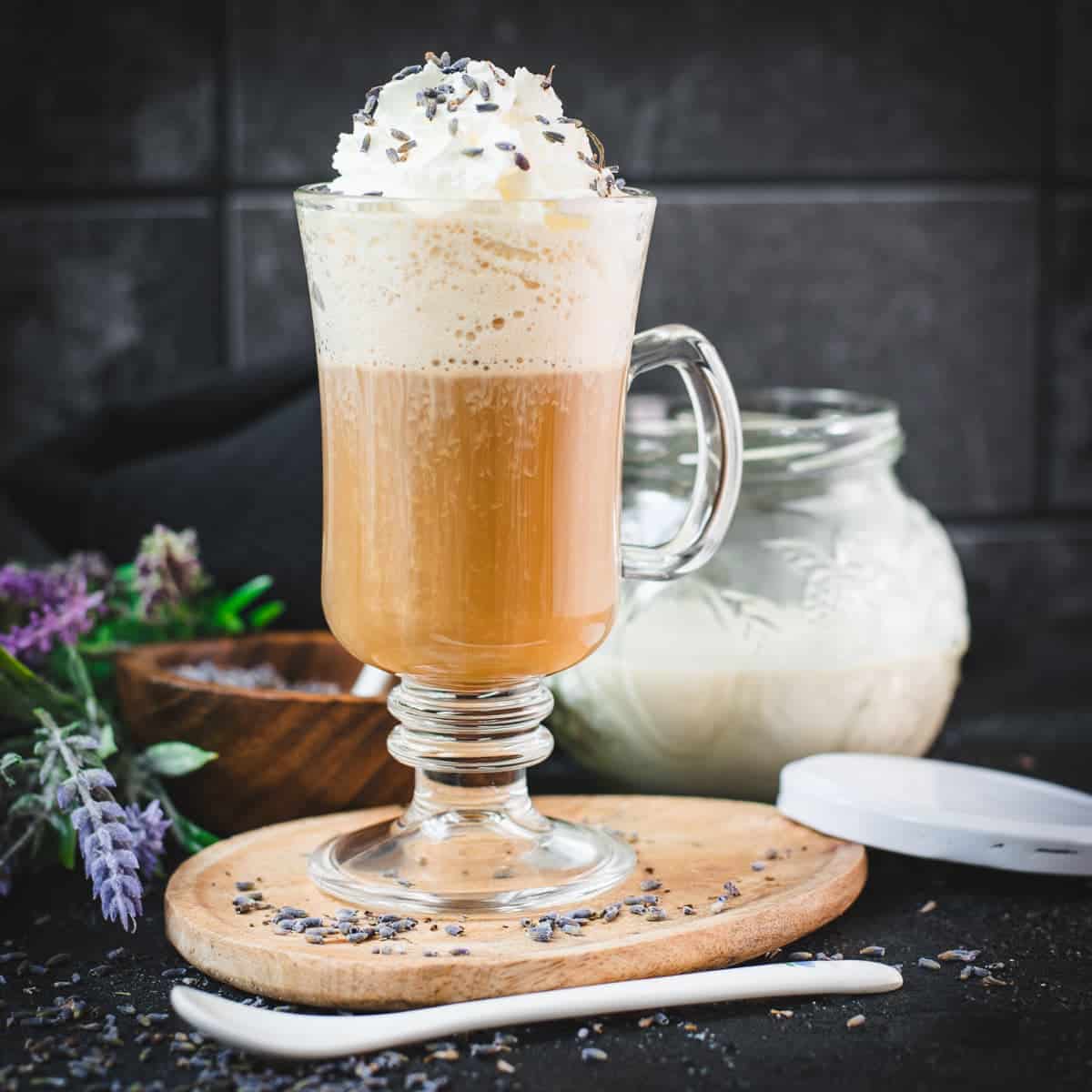 Scrumptious lavender latte, made with homemade lavender coffee creamer. Topped with whipped cream and sprinkled with dried lavender buds.