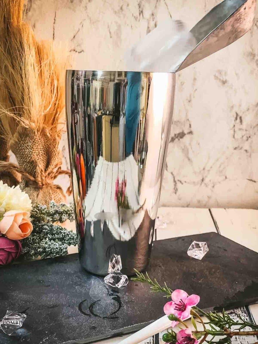 Add cubed ice to the cocktail shaker.