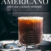 Stunning and delicious iced Americano, served in a gorgeous glass and placed on a black slate plate.