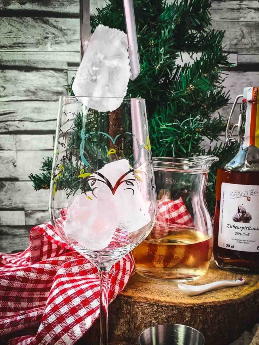 Add cubed ice to the glass.