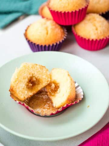 Halved coconut muffin with the fig jam center clearly visible.