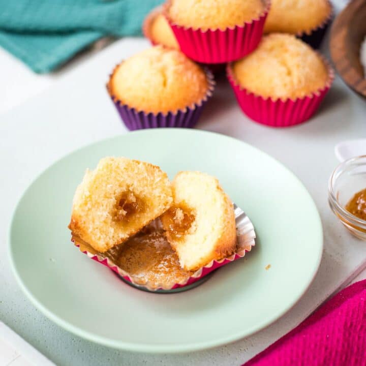 Halved coconut muffin with the fig jam center clearly visible.