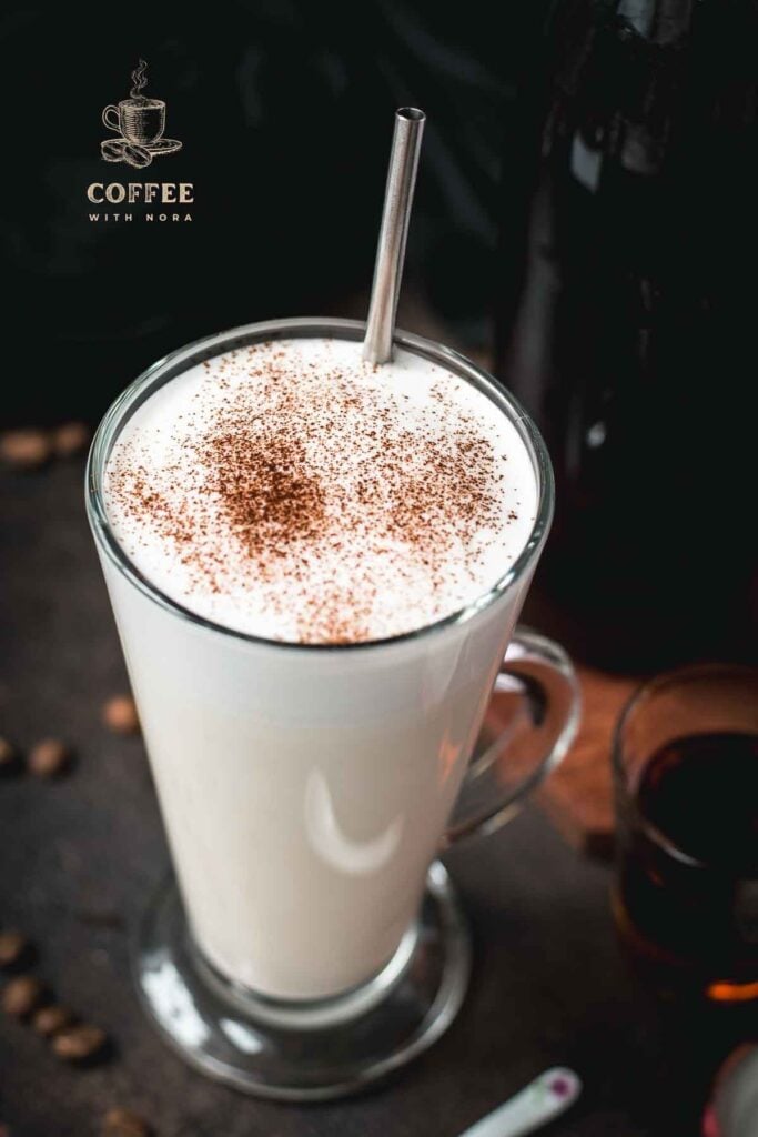 Beautiful glass filled with hot milk and homemade coffee syrup. Topped with frothed milk and dusted with cinnamon.